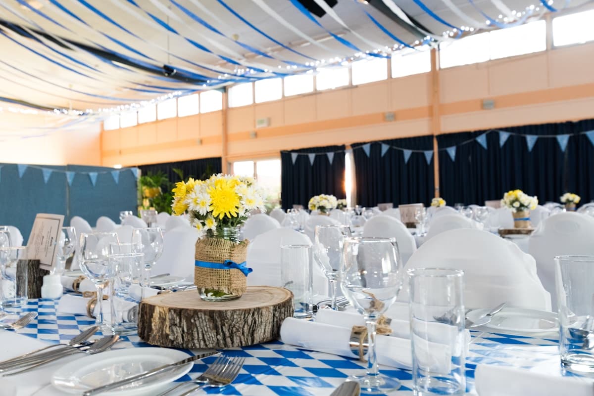 Gala reception dining room adorned with yellow floral arrangements
